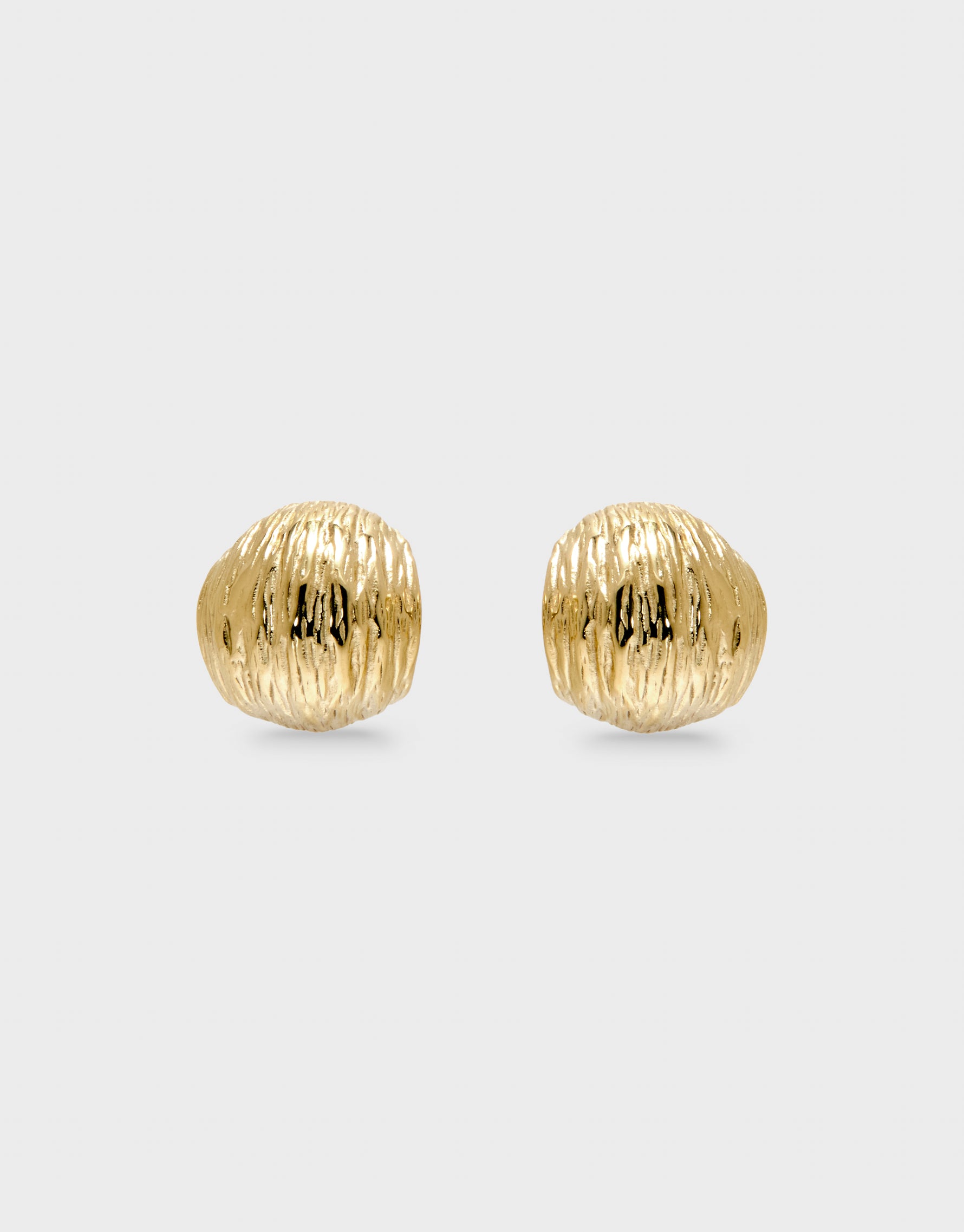 Pair of gold textured earrings on a light gray background