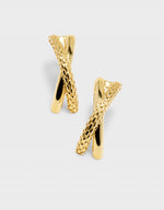 Gold earrings with a textured design on a light gray background