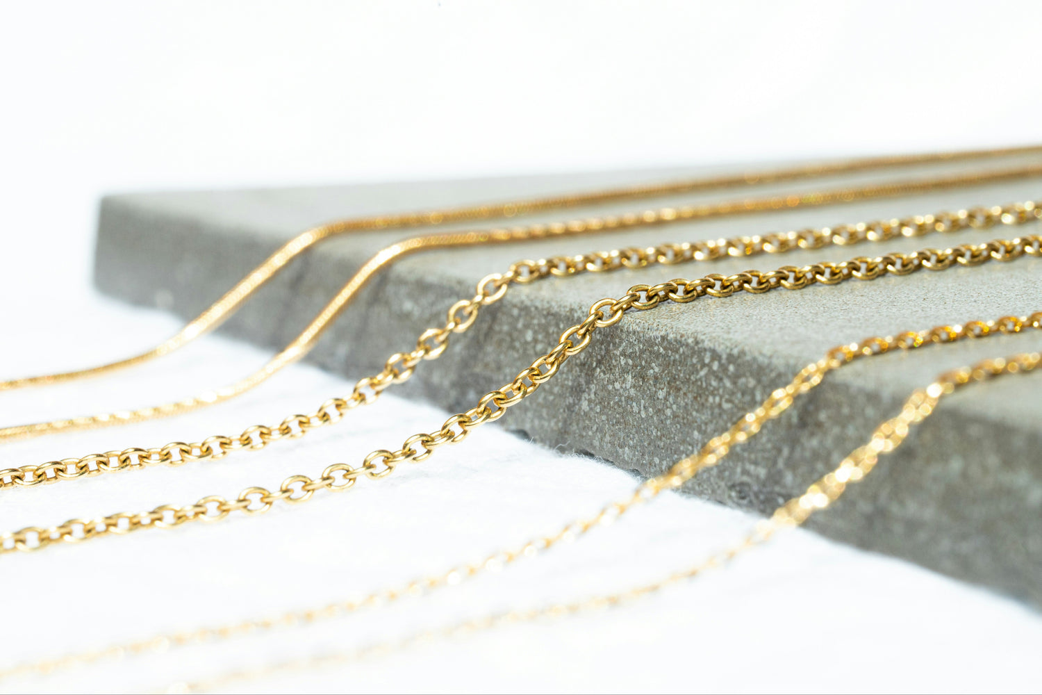 Set of gold chains on a white background